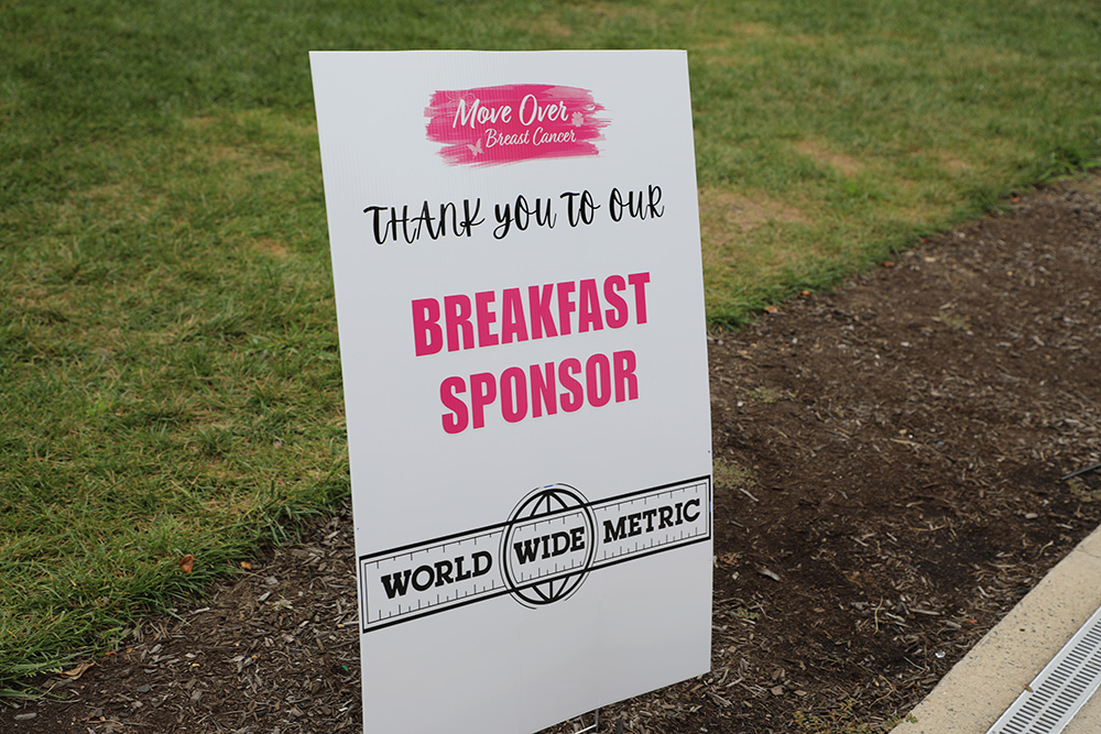 Sign reading Thank you to our Breakfast Sponsor &ndash; World Wide Metric at a Move Over Breast Cancer event