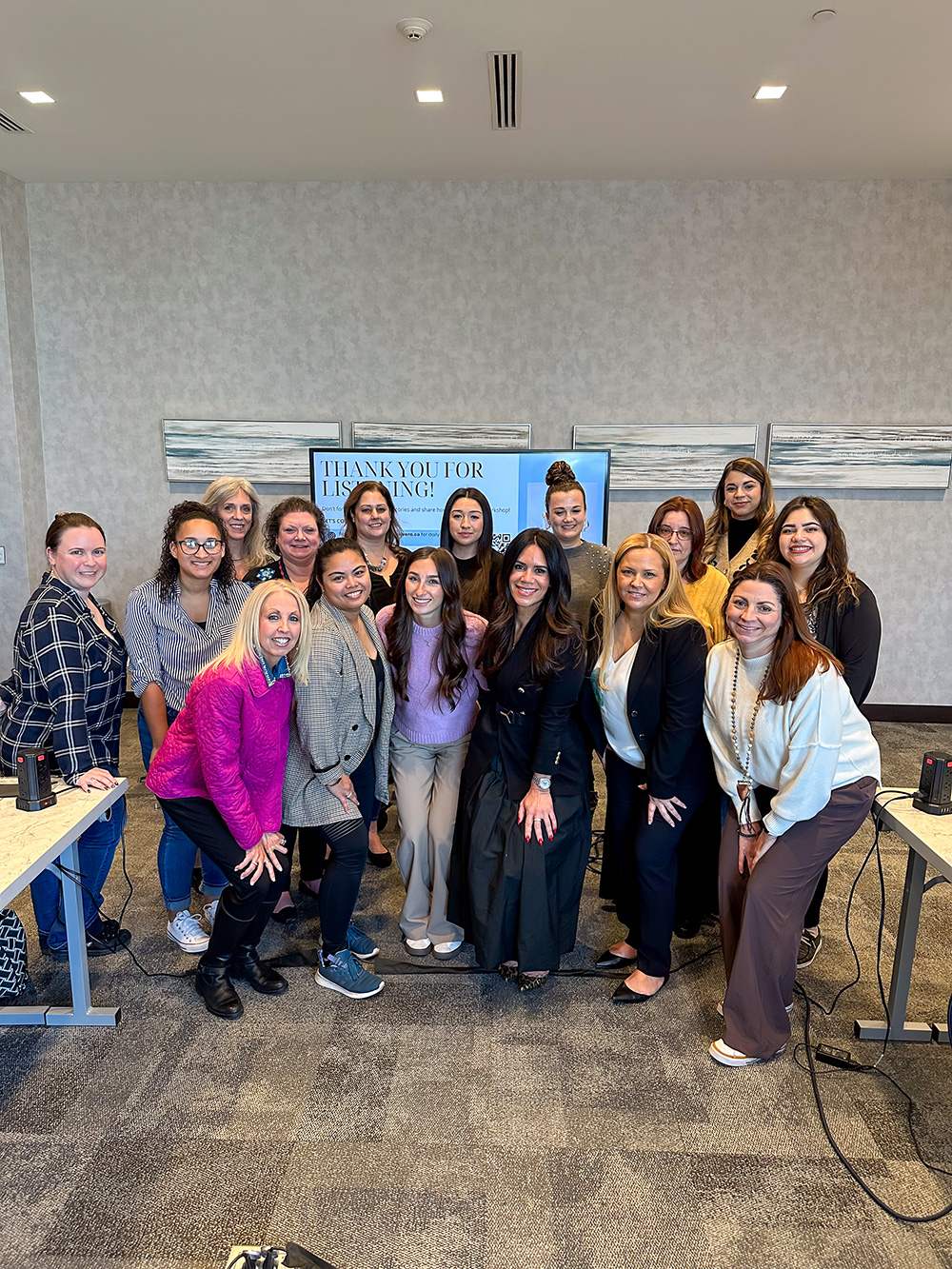 Women Who Metric group photo in front of a Thank You for Listening presentation screen