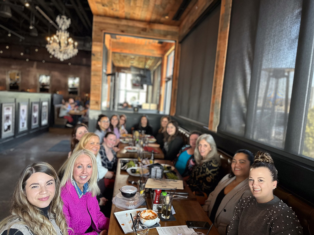 Women Who Metric members at a group dinner at a restaurant