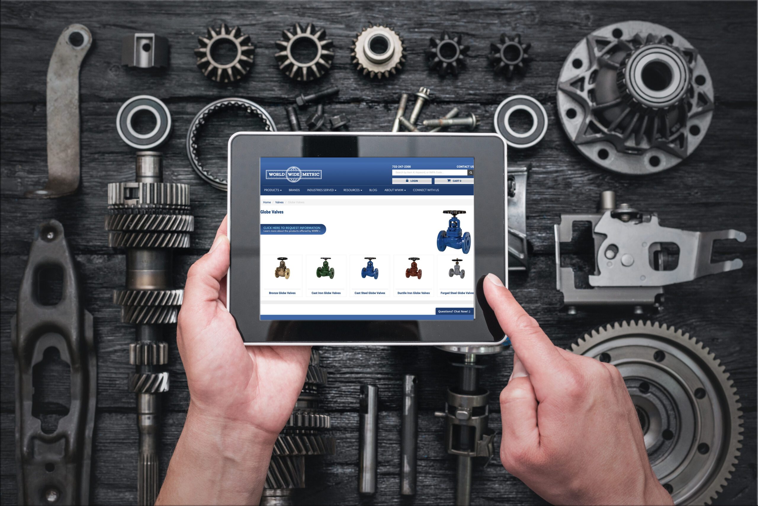 Tablet showing the World Wide Metric online catalog surrounded by industrial parts